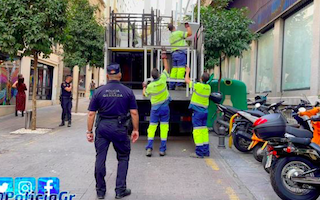 GRA municipal police load up confiscated terrace furniture