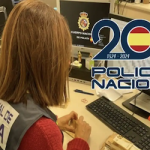 SPN Female Policia Nacional officer at a computer.